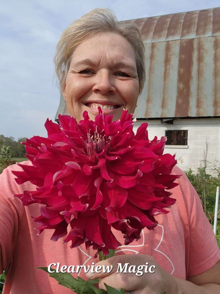 A woman holding a flower in her hands.